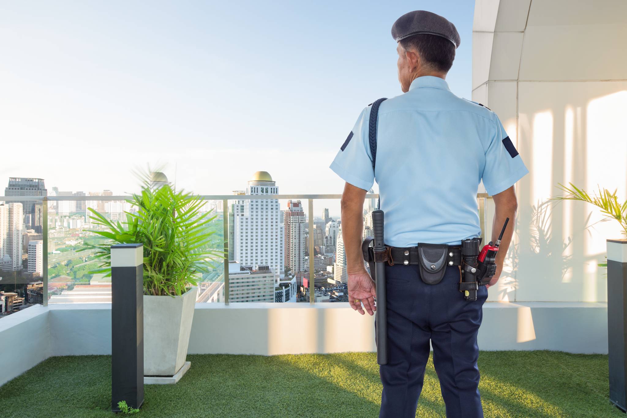 Security guard of condominium watching surveillance